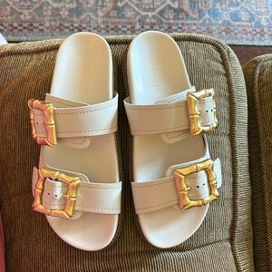 Schutz ivory slides with gold buckle details. Brand new!  Size 7 1/2 B
